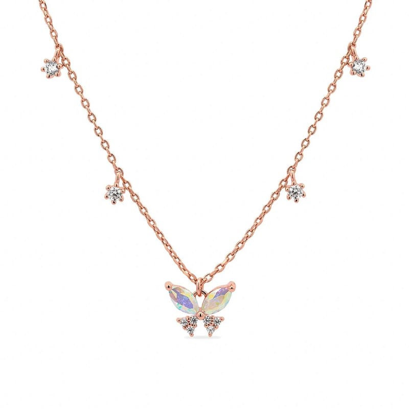 A screenshot of a real necklace. Rose gold necklace with a butterfly-shaped pendant featuring iridescent stones, accented by small flower-like clusters of clear crystals spaced along the chain.